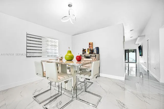 a living room with furniture a flat screen tv and a window