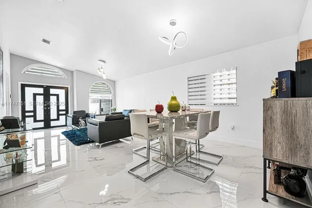 a kitchen with granite countertop a sink appliances cabinets and furniture