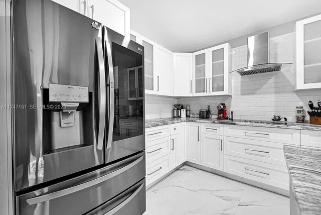 a kitchen with granite countertop cabinets and steel stainless steel appliances