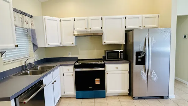 a kitchen with a sink and a refrigerator