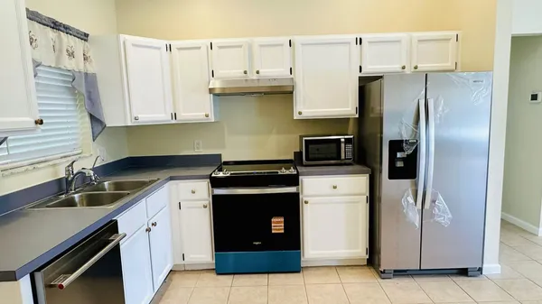 a kitchen with a sink and a refrigerator
