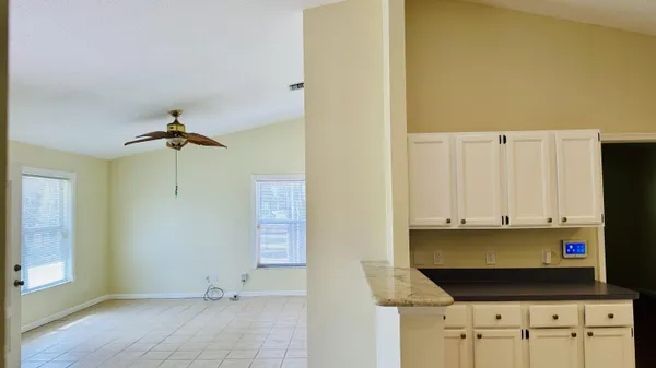 a view of a kitchen with white cabinets