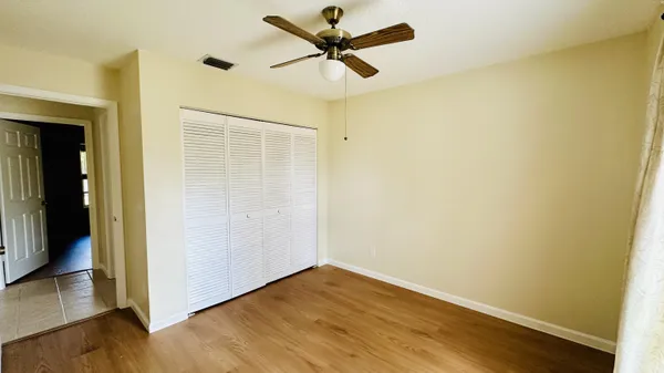 a view of a small space with wooden floor and a window