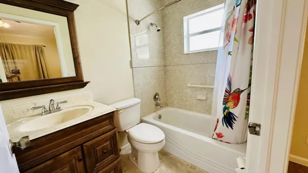 a bathroom with a sink a toilet and bathtub