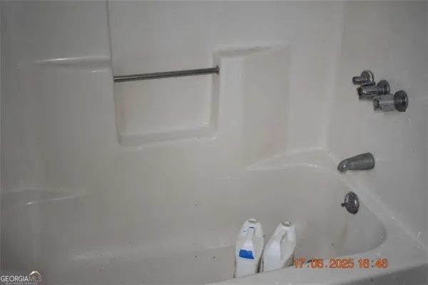 a bath tub sitting next to a shower