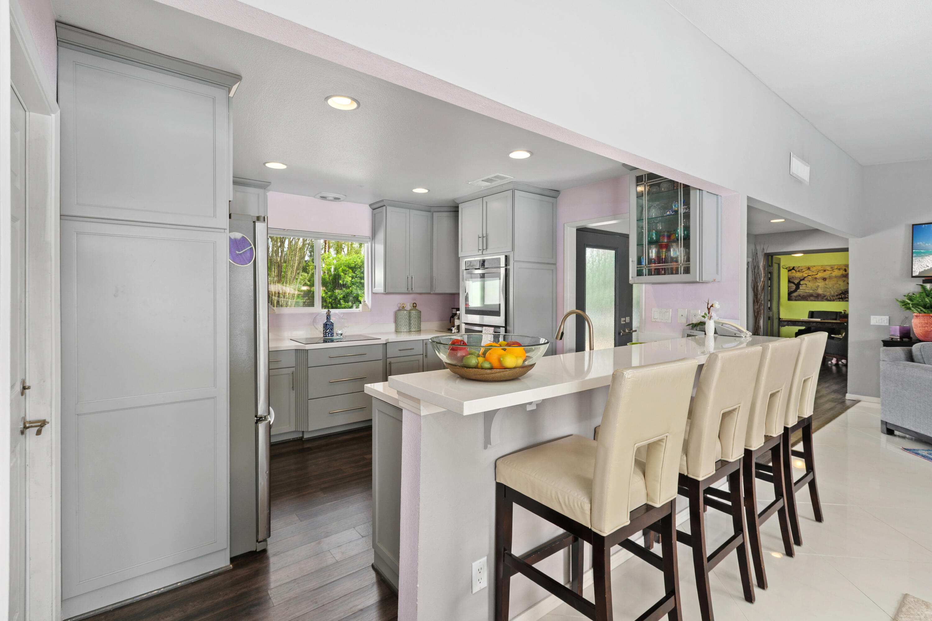 71305 Kempton Avenue Rancho Mirage, CA 92270 - Photo 22 of 58 a kitchen with stainless steel appliances a dining table chairs refrigerator and sink