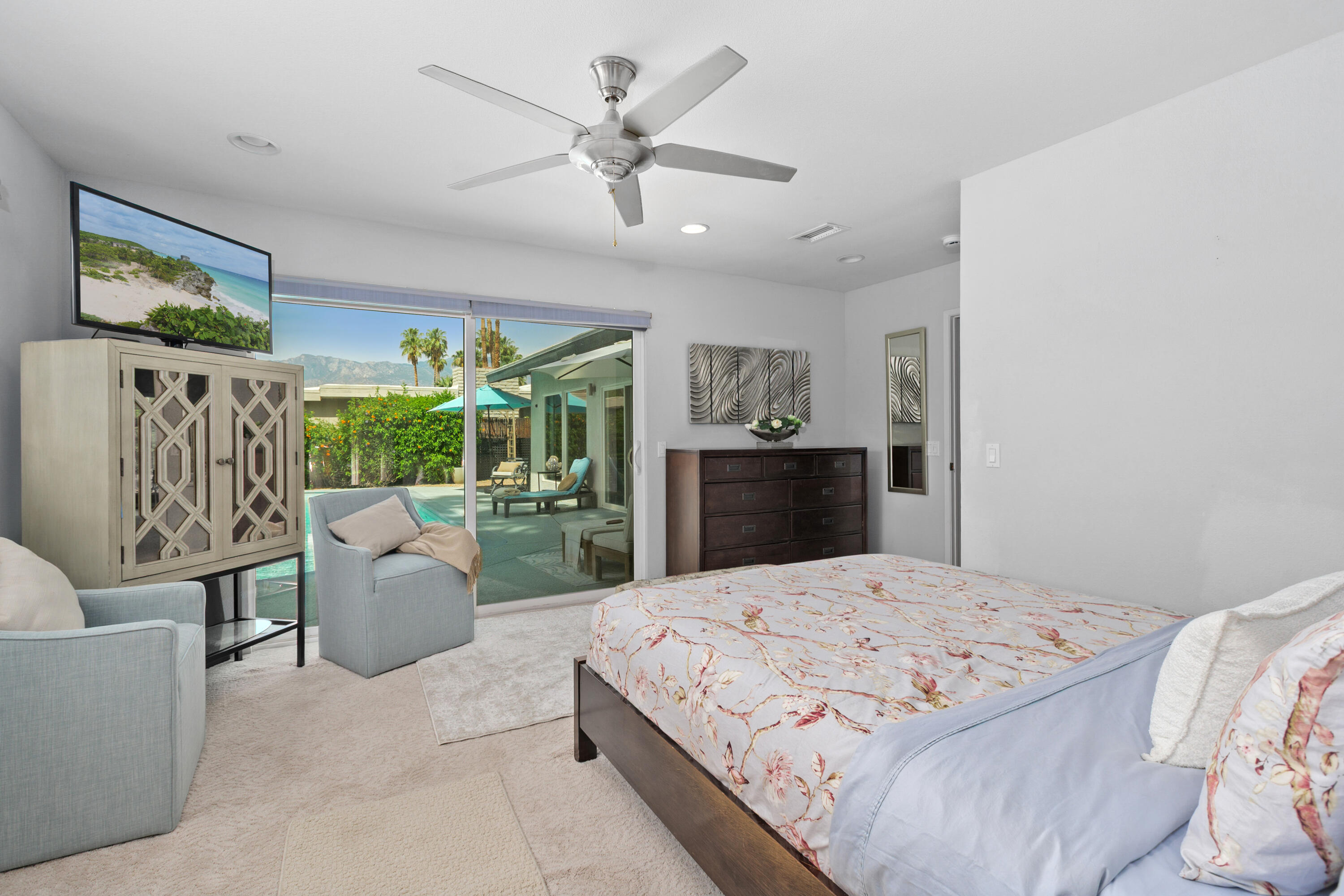 71305 Kempton Avenue Rancho Mirage, CA 92270 - Photo 32 of 58 a bedroom with a large bed couch and a window