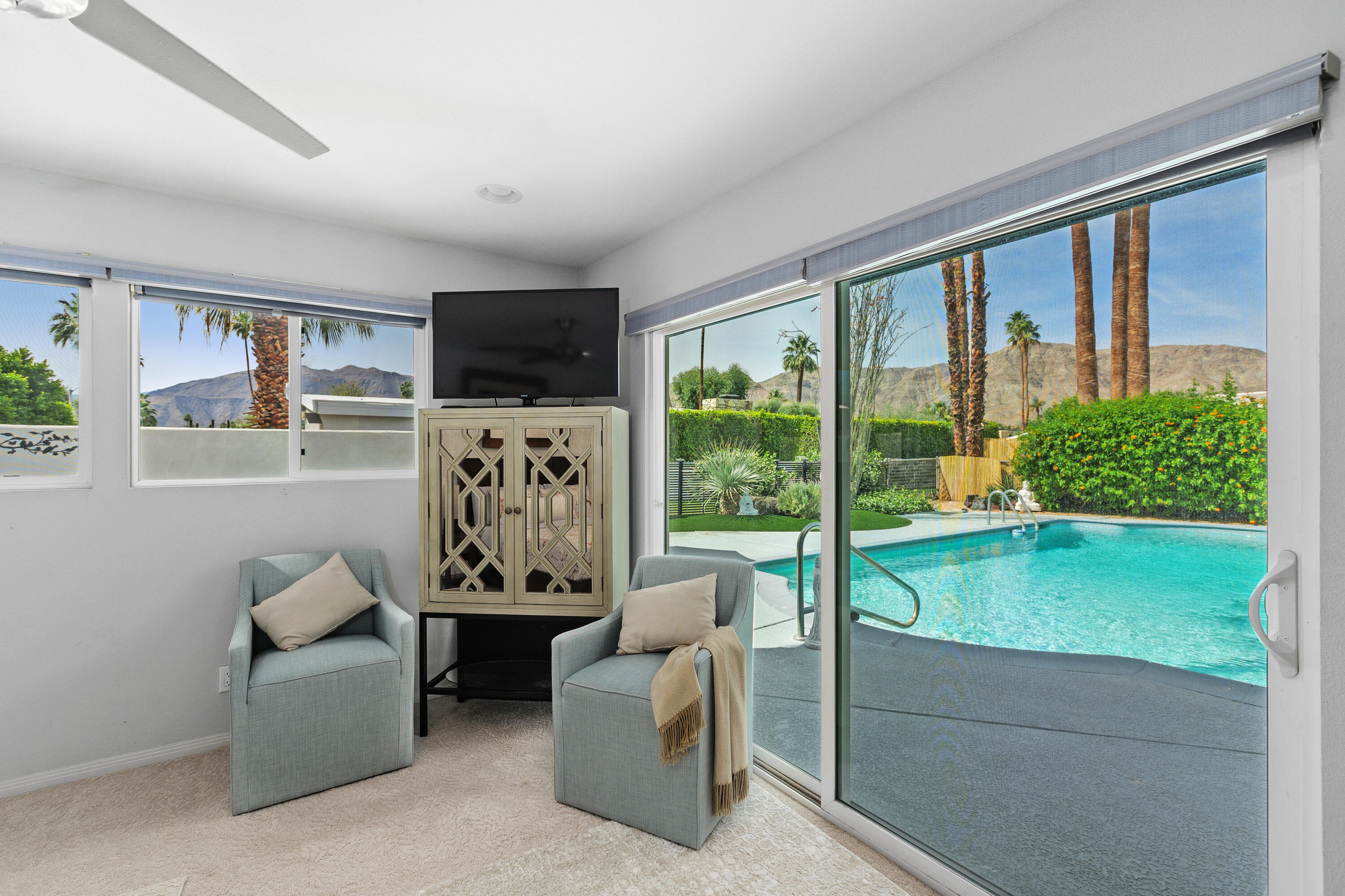 71305 Kempton Avenue Rancho Mirage, CA 92270 - Photo 33 of 58 a living room with furniture tv and a large window
