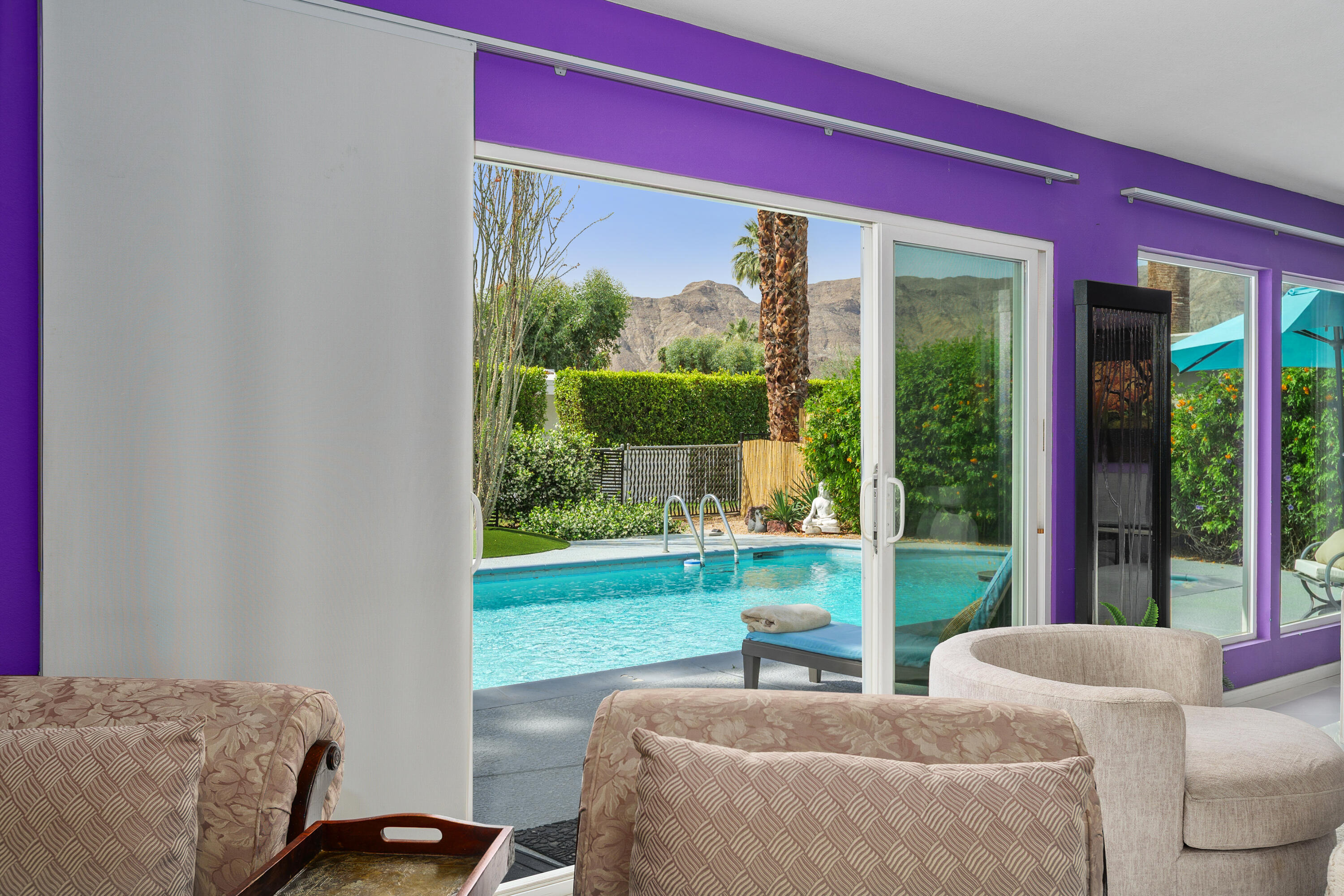 71305 Kempton Avenue Rancho Mirage, CA 92270 - Photo 39 of 58 a living room with couch floor to ceiling window and yard