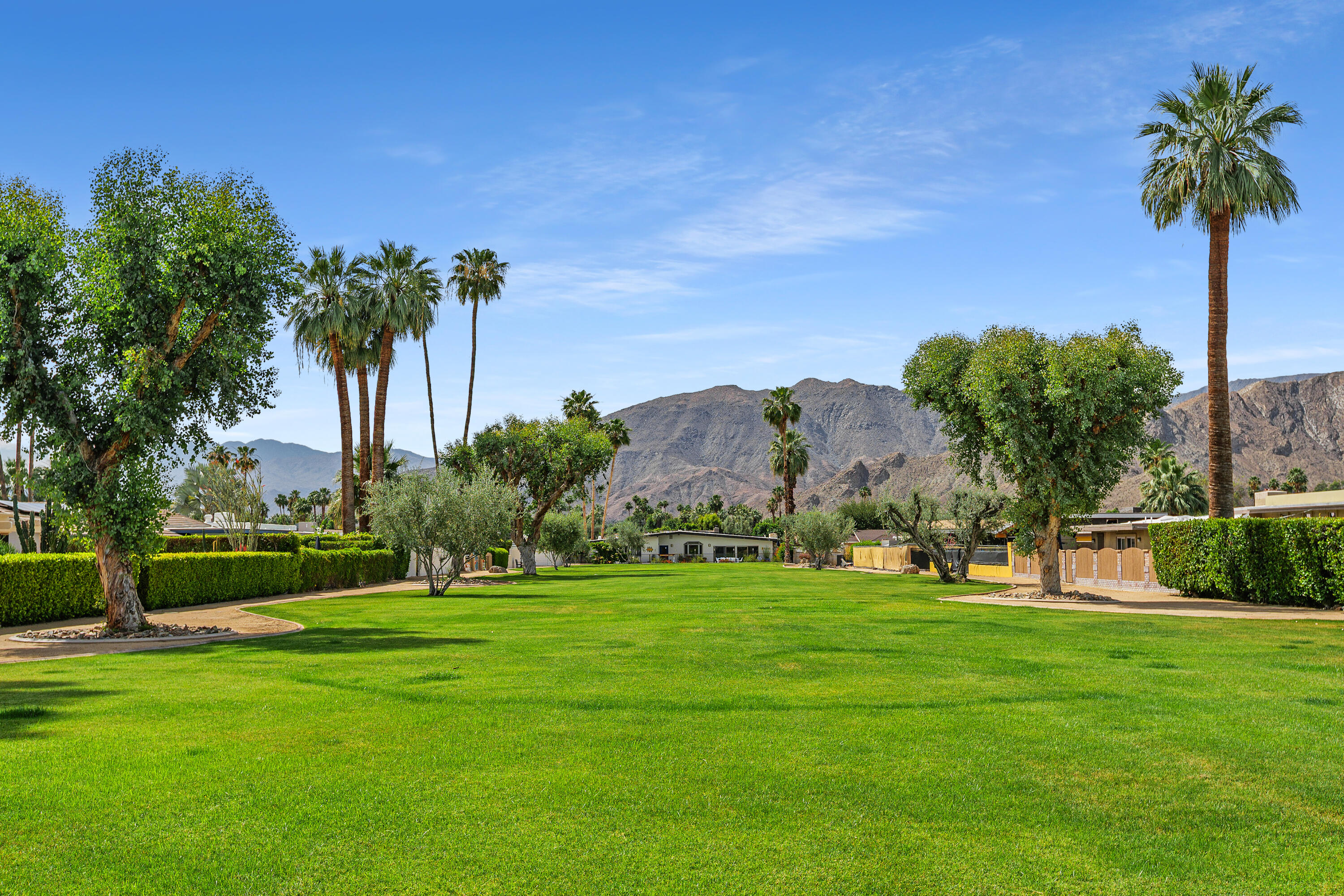 71305 Kempton Avenue Rancho Mirage, CA 92270 - Photo 4 of 58 a view of a golf course with a garden