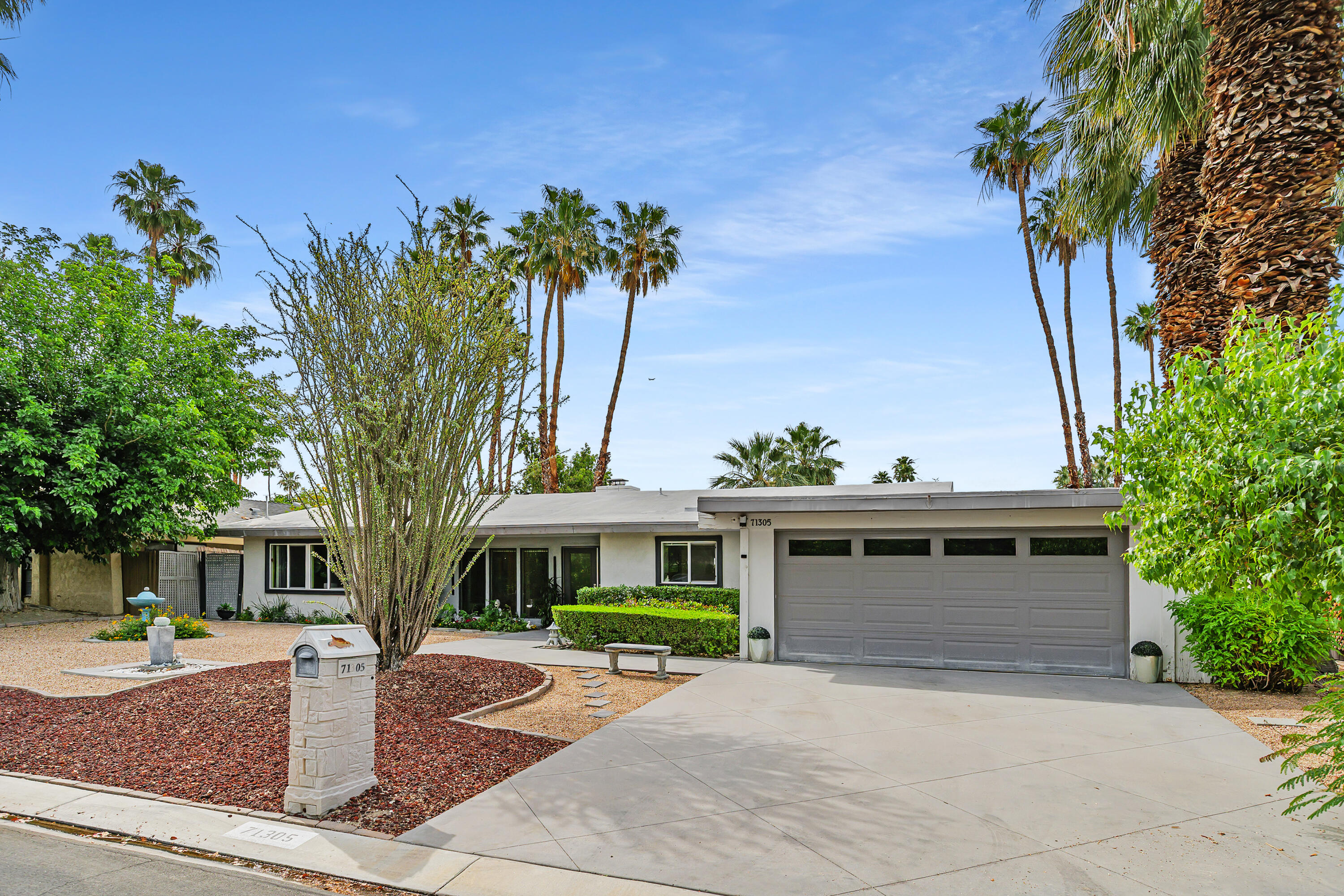 71305 Kempton Avenue Rancho Mirage, CA 92270 - Photo 49 of 58 a front view of a house with garden
