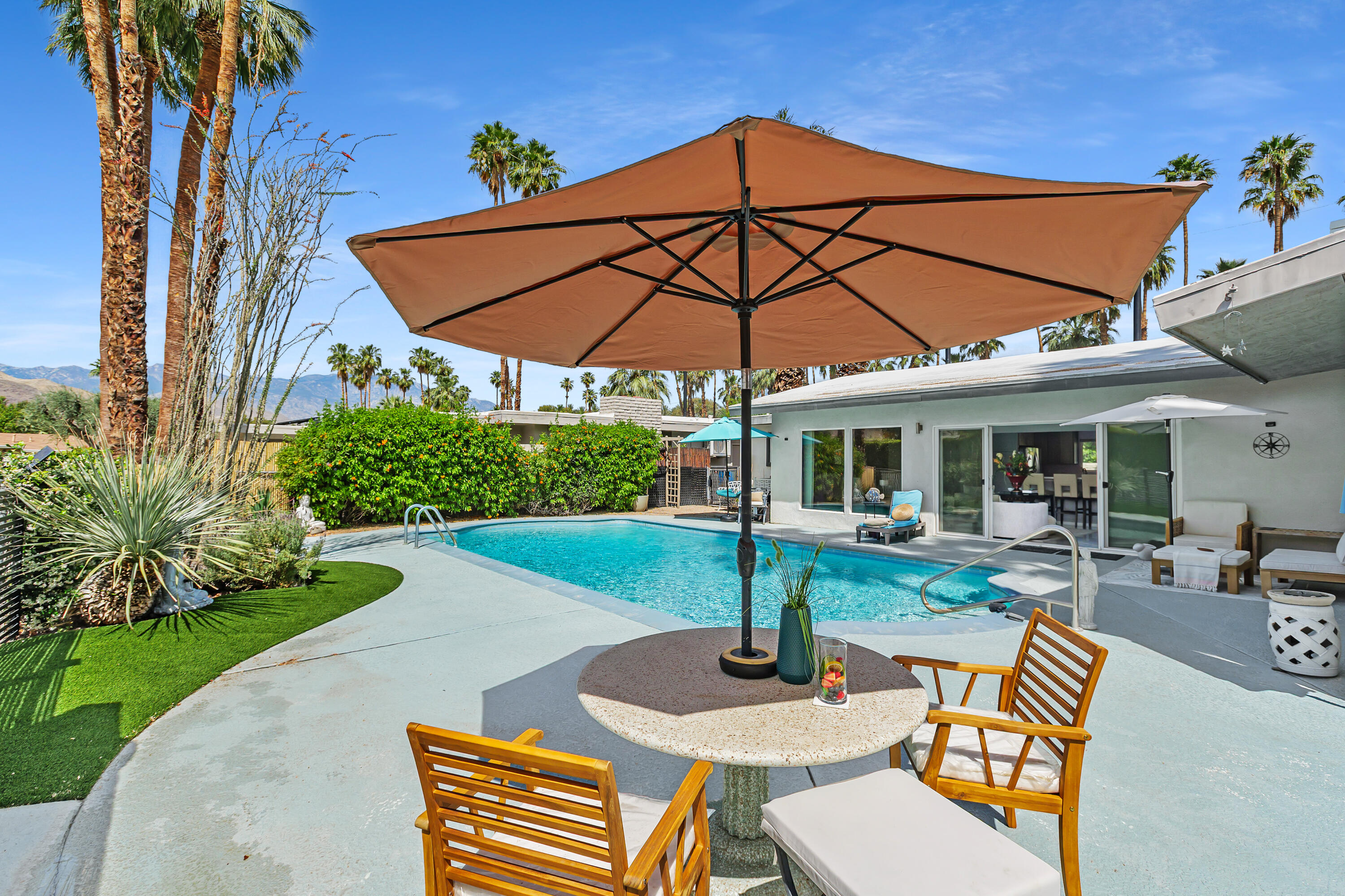 71305 Kempton Avenue Rancho Mirage, CA 92270 - Photo 5 of 58 a view of a house with backyard sitting area and swimming pool