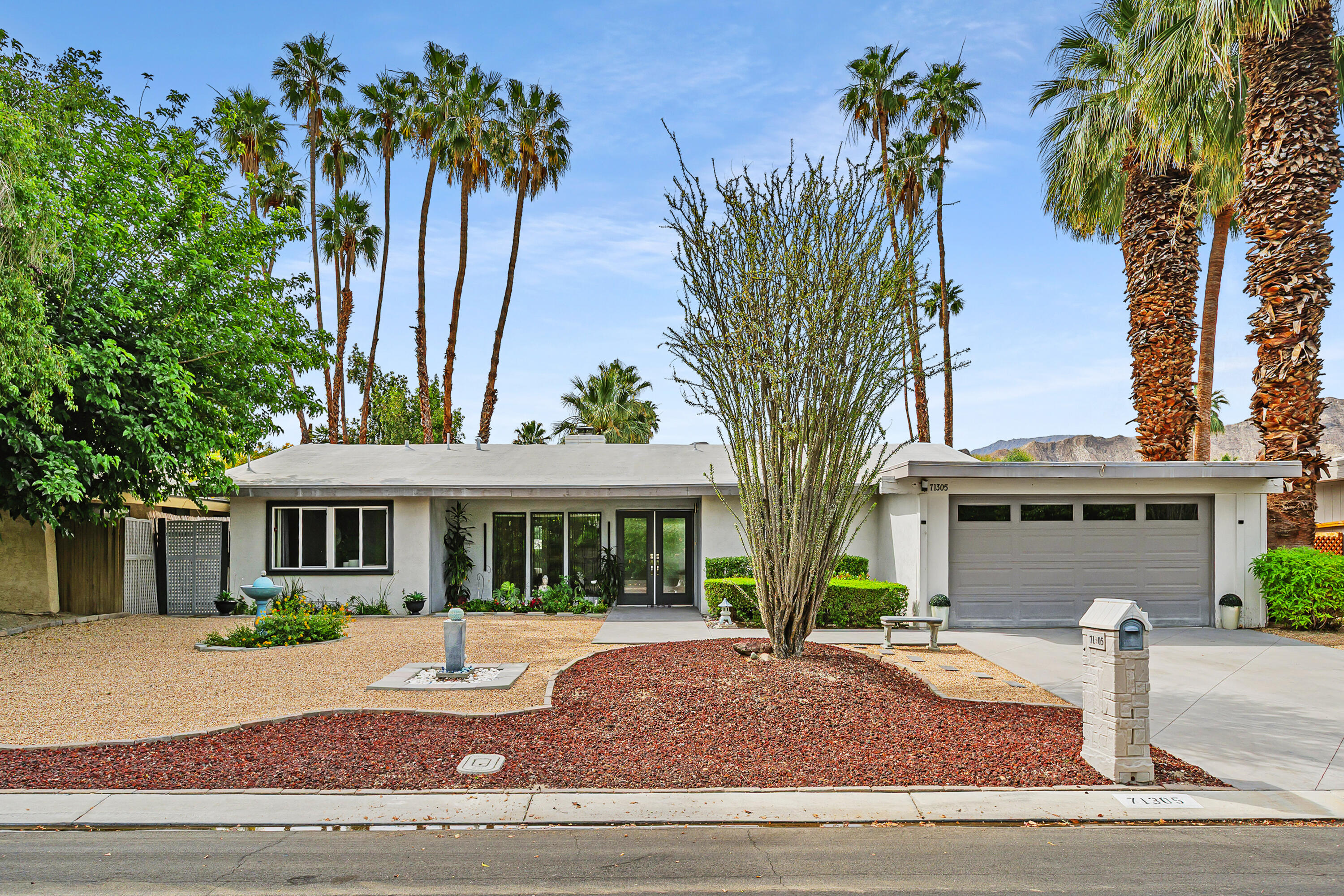 71305 Kempton Avenue Rancho Mirage, CA 92270 - Photo 52 of 58 a front view of a house with a garden