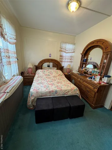 a bedroom with bed and a window