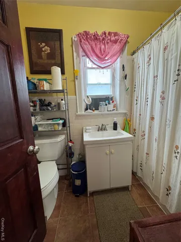 a bathroom with a sink toilet vanity and tub