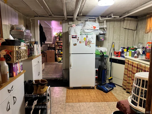 a utility room with dryer washer and stair