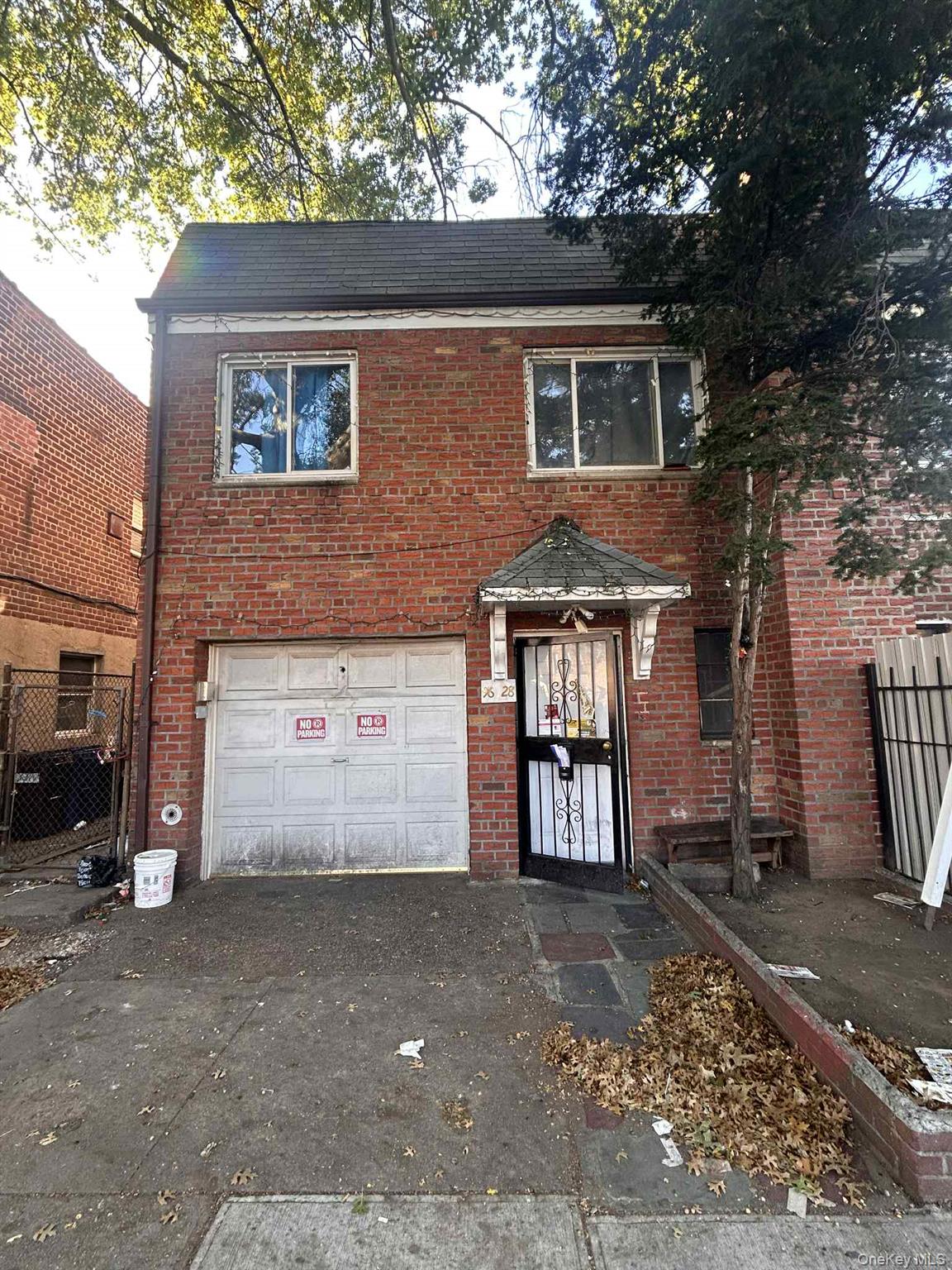 Traditional-style home with brick siding, driveway, and a garage