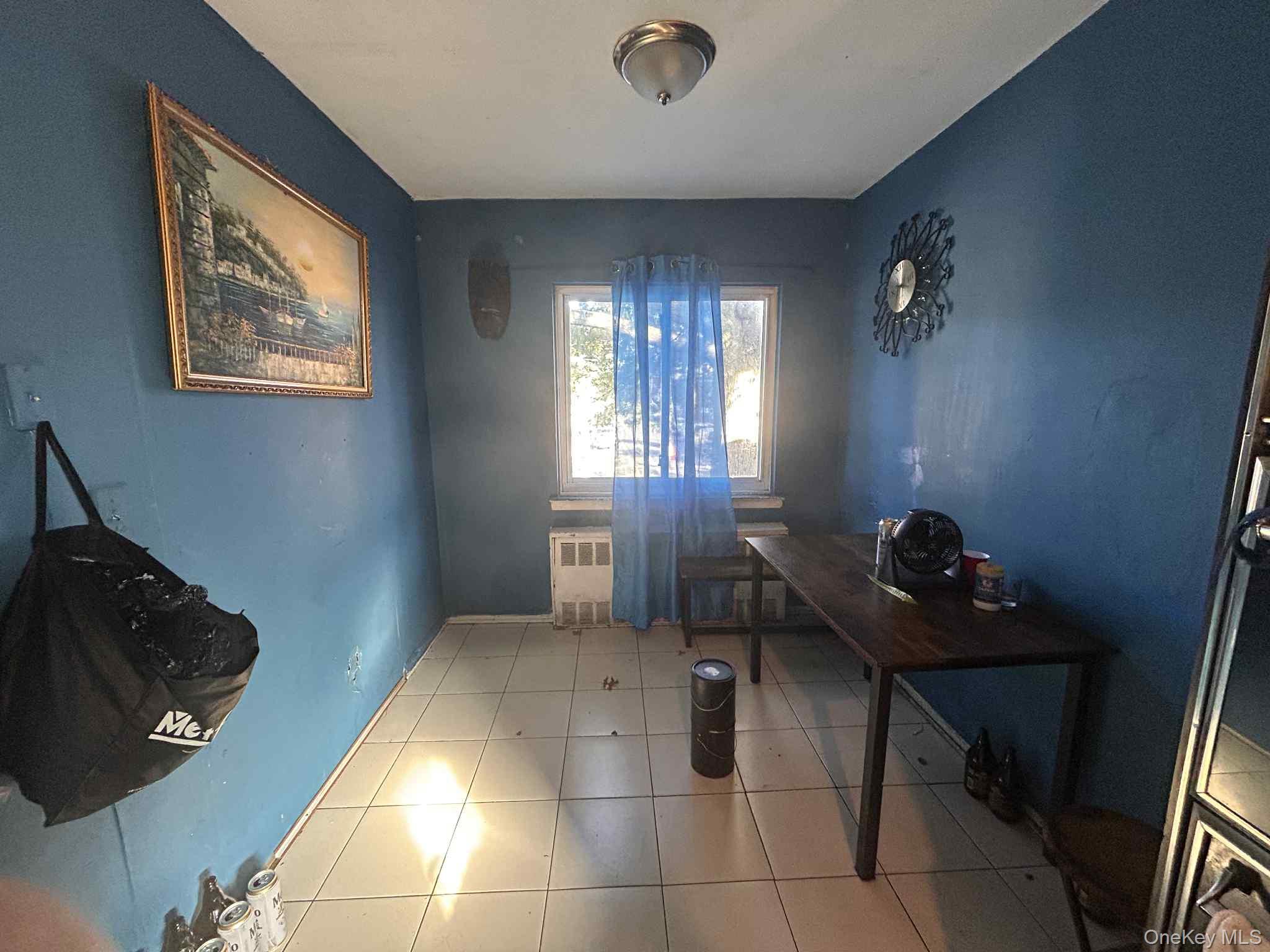 96-28 41st Avenue Queens, NY 11368 - Photo 4 of 5 Office area featuring tile patterned floors and radiator heating unit