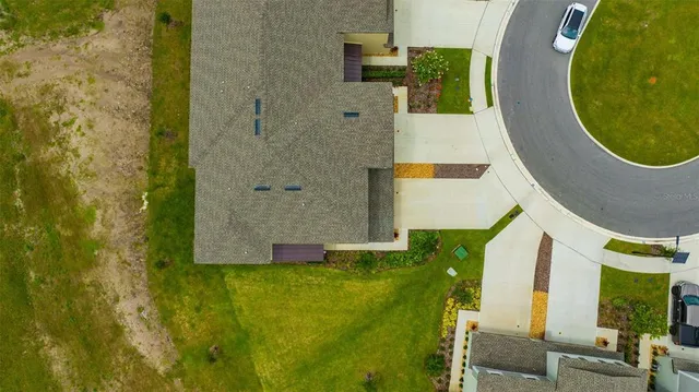 an aerial view of a house with a garden