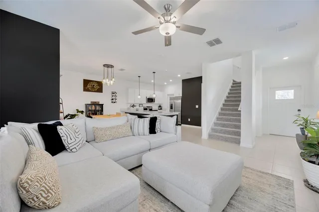 a living room with furniture and wooden floor