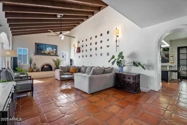 a living room with furniture a fireplace and a flat screen tv