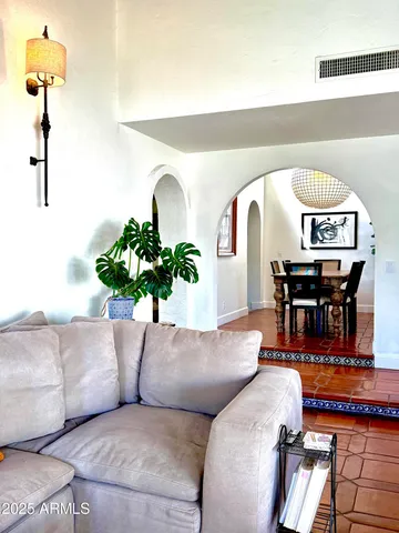 a living room with furniture and a potted plant