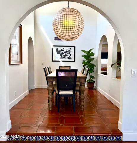 a living room with a couch and a potted plant