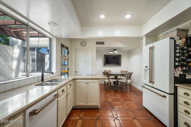 a kitchen with cabinets stainless steel appliances and sink