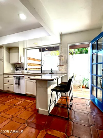 a kitchen with stainless steel appliances granite countertop a sink and a refrigerator
