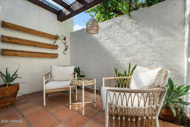 a balcony with table and chairs