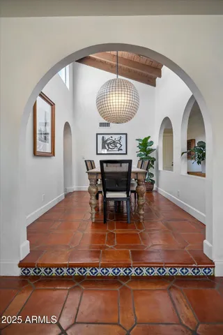 a living room with furniture a fireplace and a floor to ceiling window