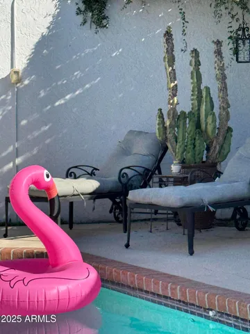 a view of swimming pool with outdoor seating