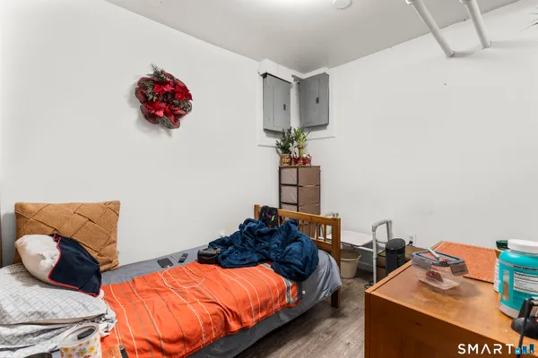 a bedroom with two bed and a chandelier