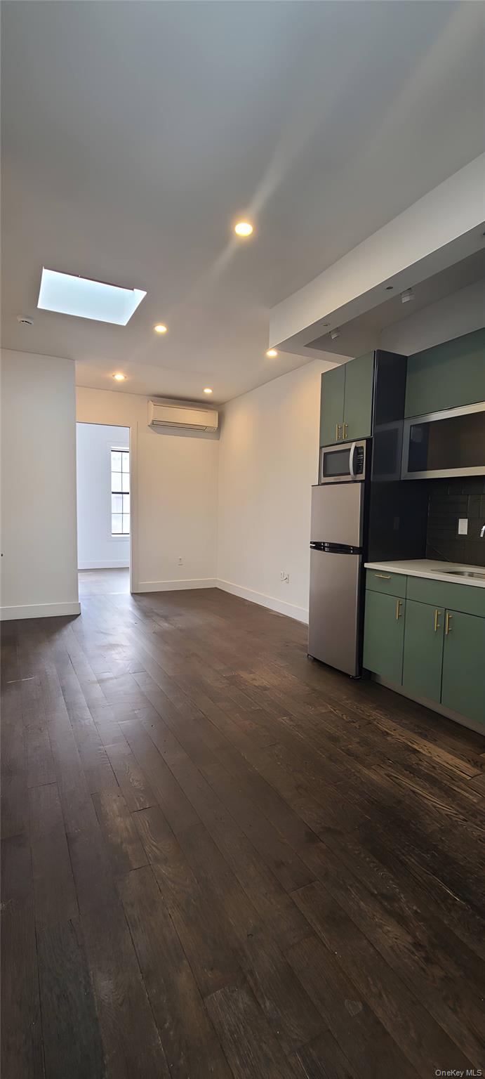 548 Howard Avenue, Unit 2L Brooklyn, NY 11233 - Photo 2 of 7 a view of empty room with wooden floor