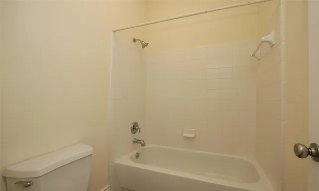 a bathroom with a bathtub and a toilet