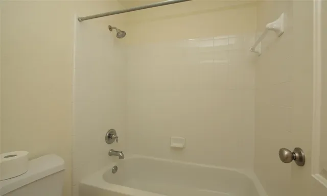 a bathroom with a shower and a toilet
