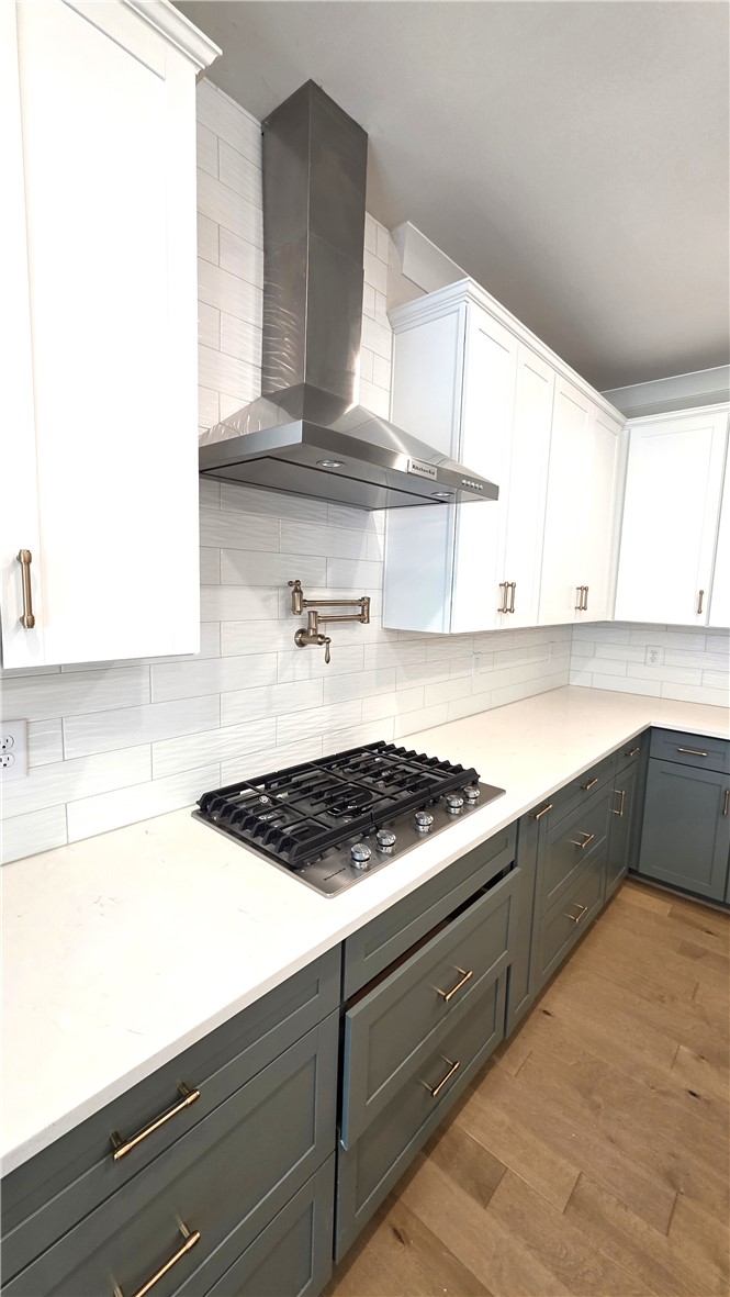 243 Holly Br Road Piedmont, SC 29673 - Photo 12 of 21 Culinary delights await in this modern kitchen featuring a gas cooktop and sleek range hood.