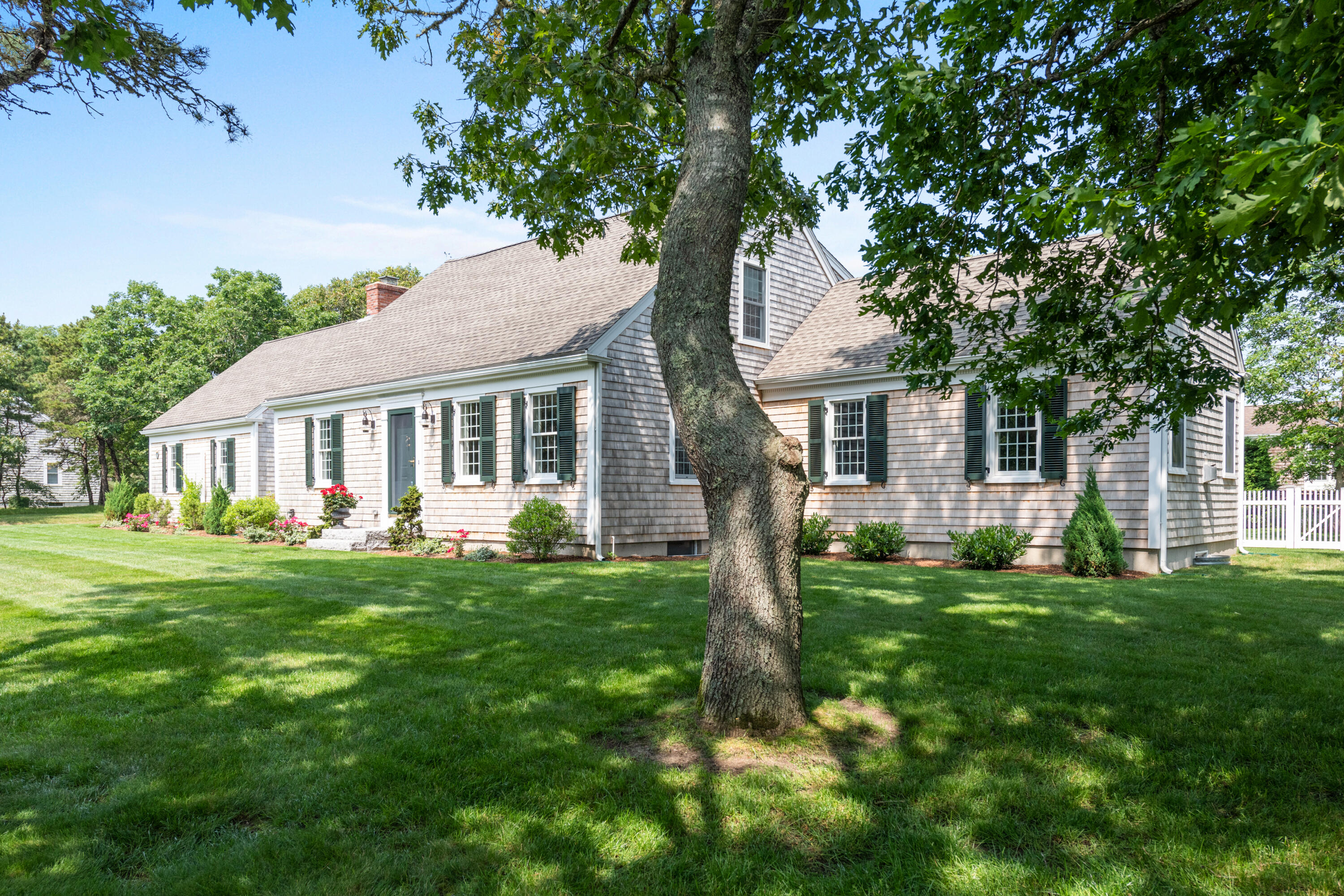 15 Deer Run Harwich, MA 02645 - Photo 1 of 34 a front view of house with a garden and trees