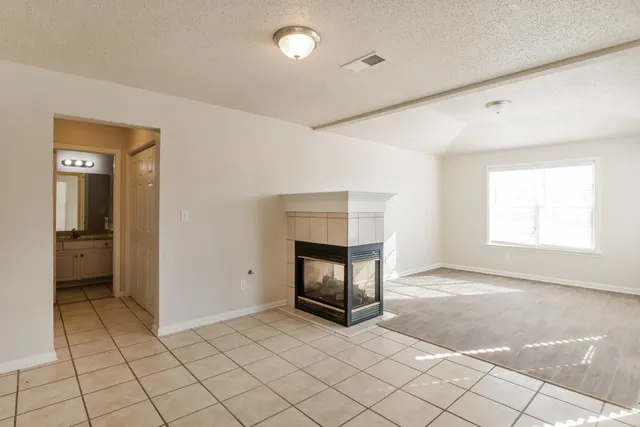 a view of an empty room and fire place
