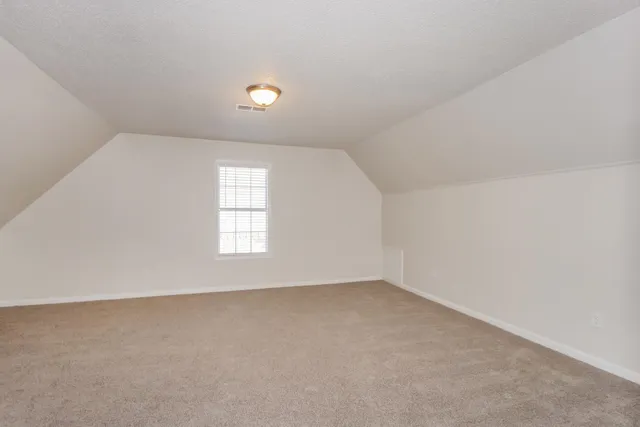 an empty room with a empty space and windows