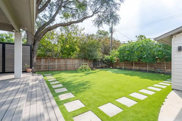 a view of a house with swimming pool and a big yard
