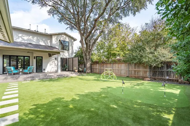 a swimming pool with outdoor seating and yard