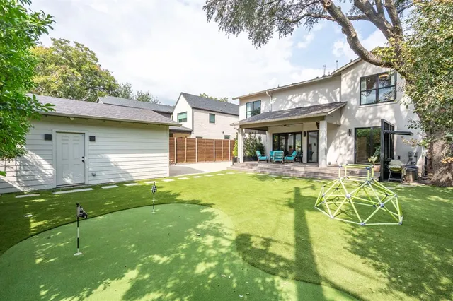 a backyard of a house with table and chairs