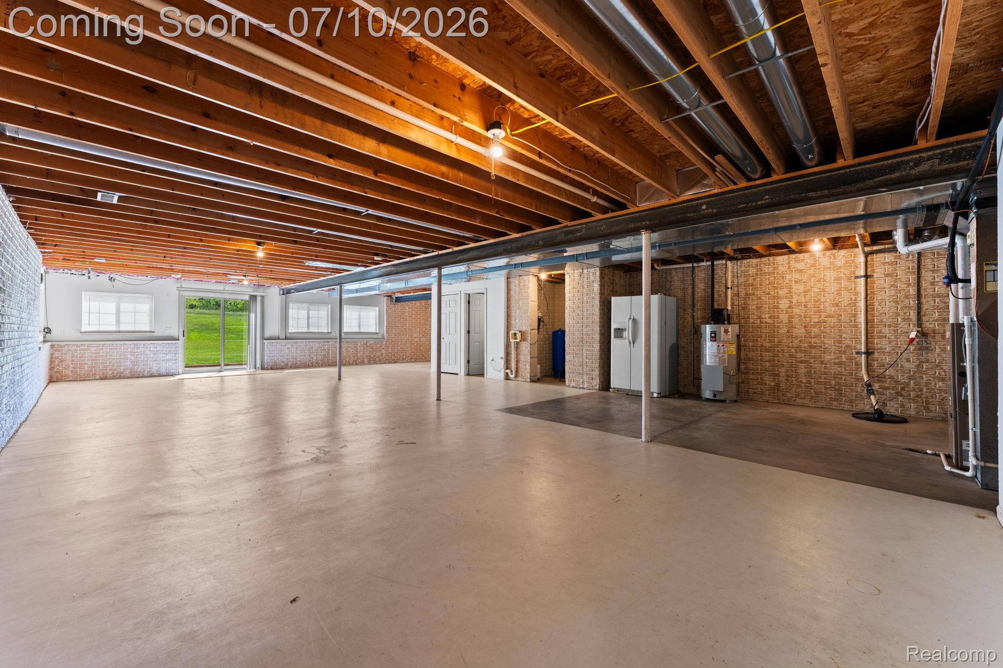 3144 North Nicholson Road Fowlerville, MI 48836 - Photo 60 of 70 Expansive unfinished basement featuring concrete flooring and exposed wood ceiling joists