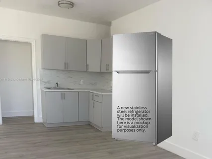 a view of kitchen with white cabinets