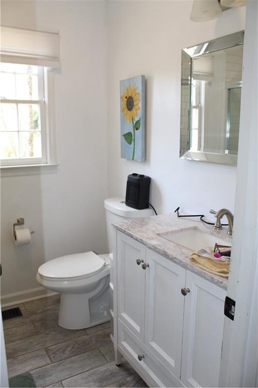 40 Chestatee Springs Road Dahlonega, GA 30533 - Photo 13 of 43 a bathroom with a granite countertop toilet sink and mirror