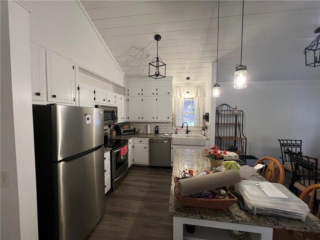 40 Chestatee Springs Road Dahlonega, GA 30533 - Photo 25 of 42 a kitchen with stainless steel appliances kitchen island granite countertop a refrigerator a sink dishwasher a oven a dining table and chairs with wooden floor