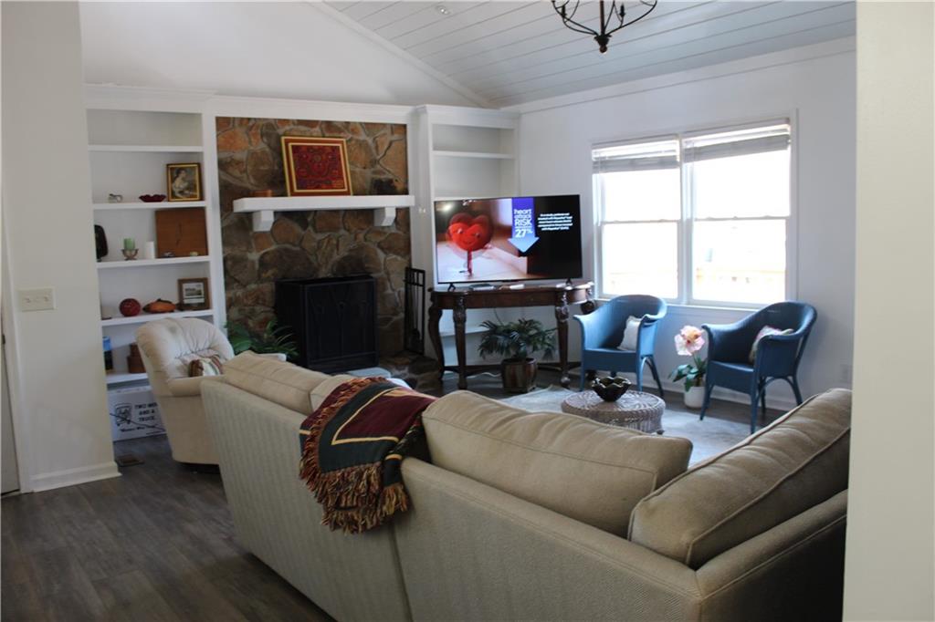 40 Chestatee Springs Road Dahlonega, GA 30533 - Photo 27 of 43 a living room with furniture a fireplace and a flat screen tv