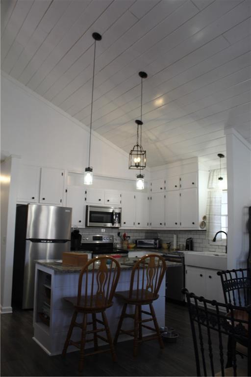 40 Chestatee Springs Road Dahlonega, GA 30533 - Photo 30 of 43 a kitchen with stainless steel appliances kitchen island granite countertop a dining table chairs and a refrigerator
