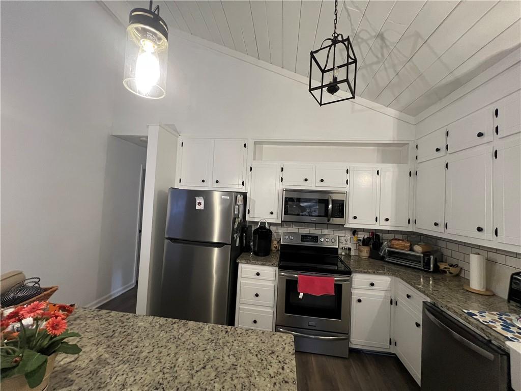 40 Chestatee Springs Road Dahlonega, GA 30533 - Photo 32 of 42 a kitchen with stainless steel appliances granite countertop a refrigerator a stove and a sink